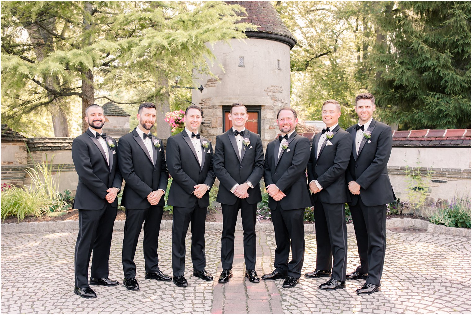 groomsmen wearing formal black tuxedos