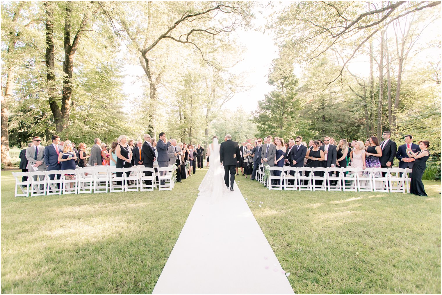 bride's processional in outdoor ceremony at Pleasantdale Chateau