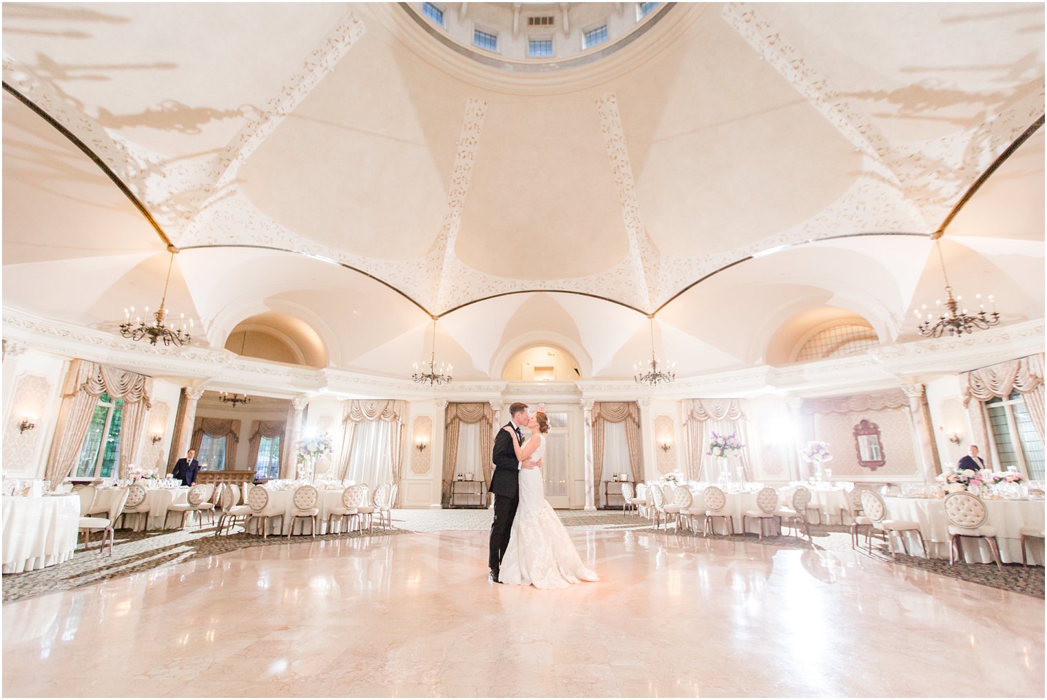 bride and groom in empty ballroom at Pleasantdale Chateau