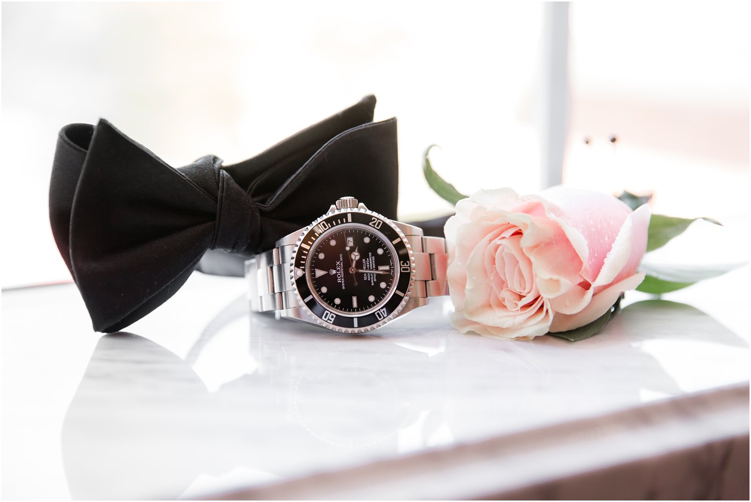 groom's Rolex watch, boutonniere, and bow tie