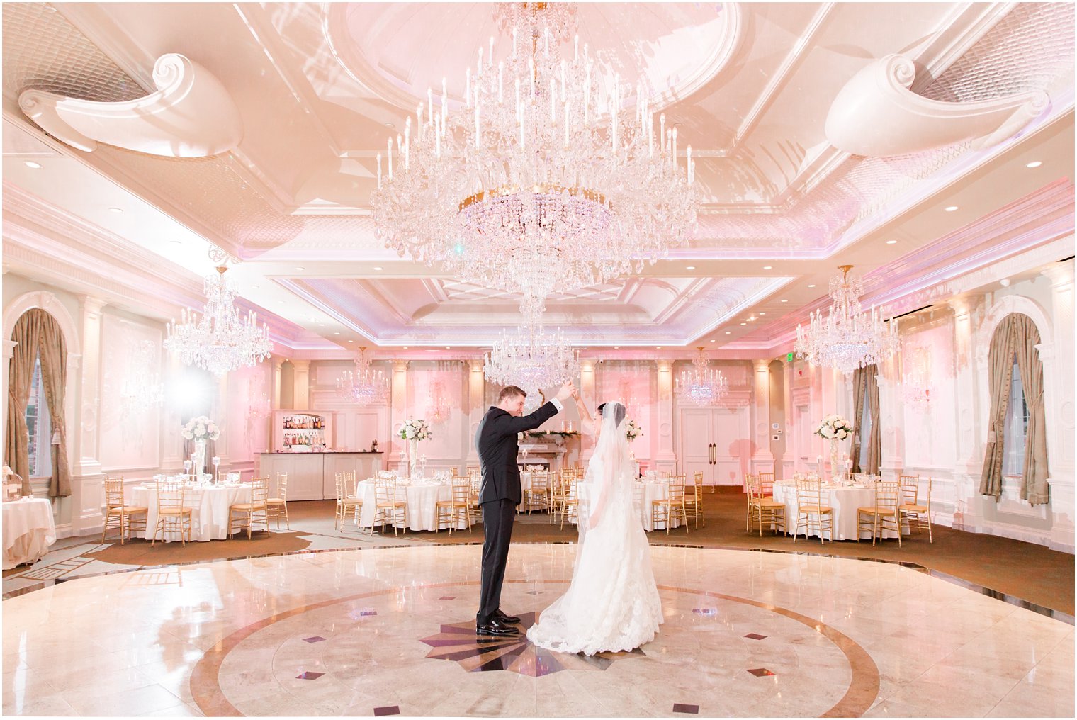 bride and groom empty ballroom photo