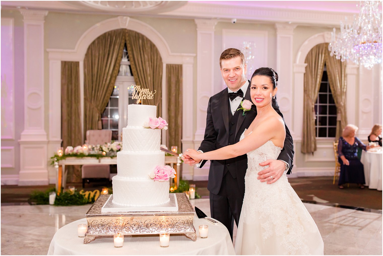 bride and groom cutting their cake at wedding reception 