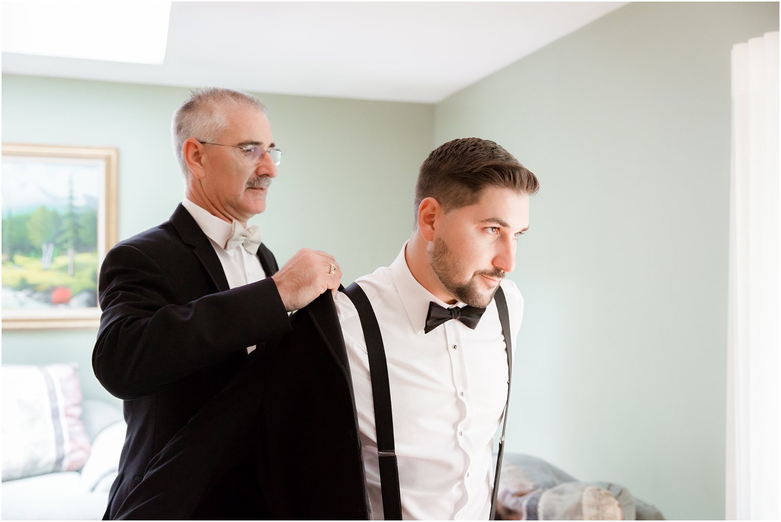 groom getting ready with his father