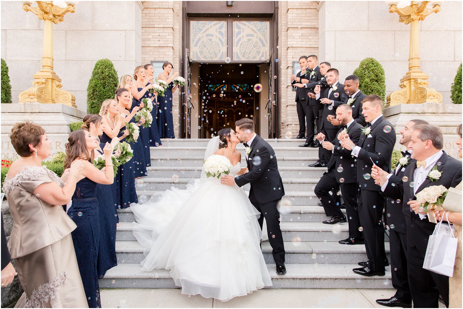 Bride and groom kissing during church exit at St. Finbar Catholic Church