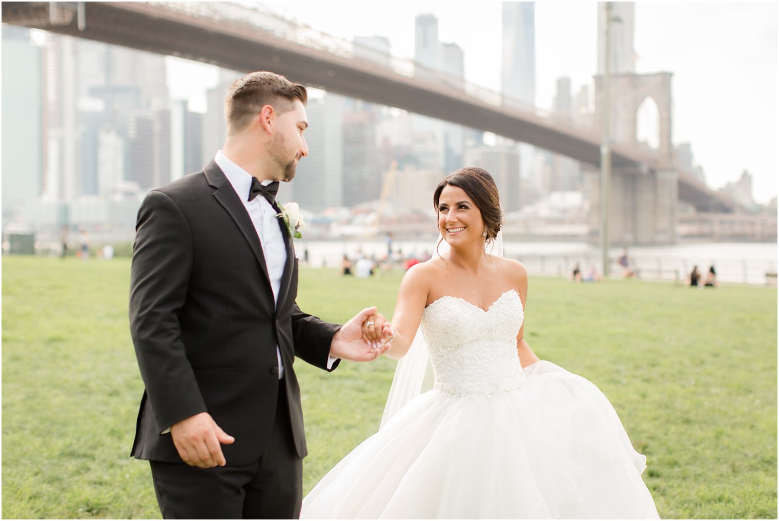 Bride and groom walking at the Brooklyn Bridge