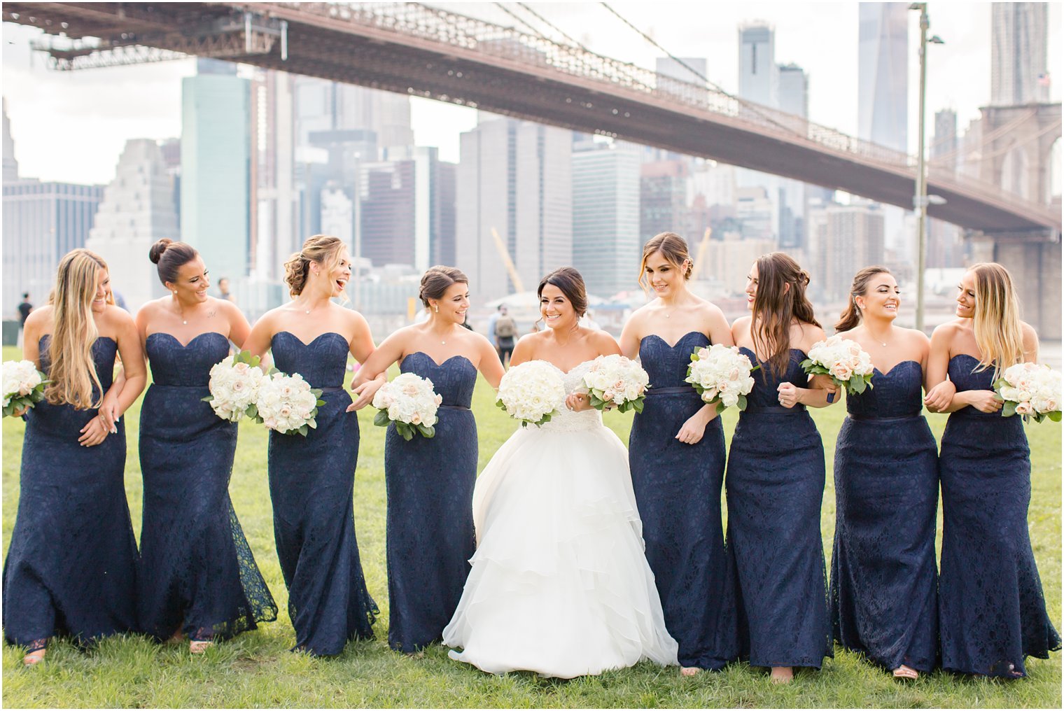 Candid photo of bridesmaids at Brooklyn Bridge