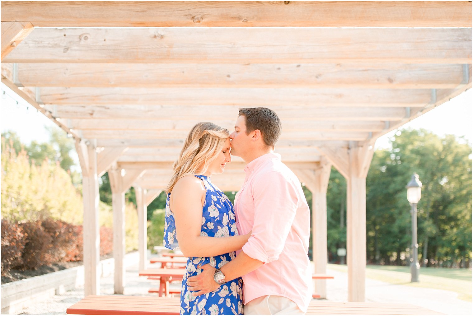 Groom-to-be gives bride-to-be a kiss on the forehead at Laurita Winery