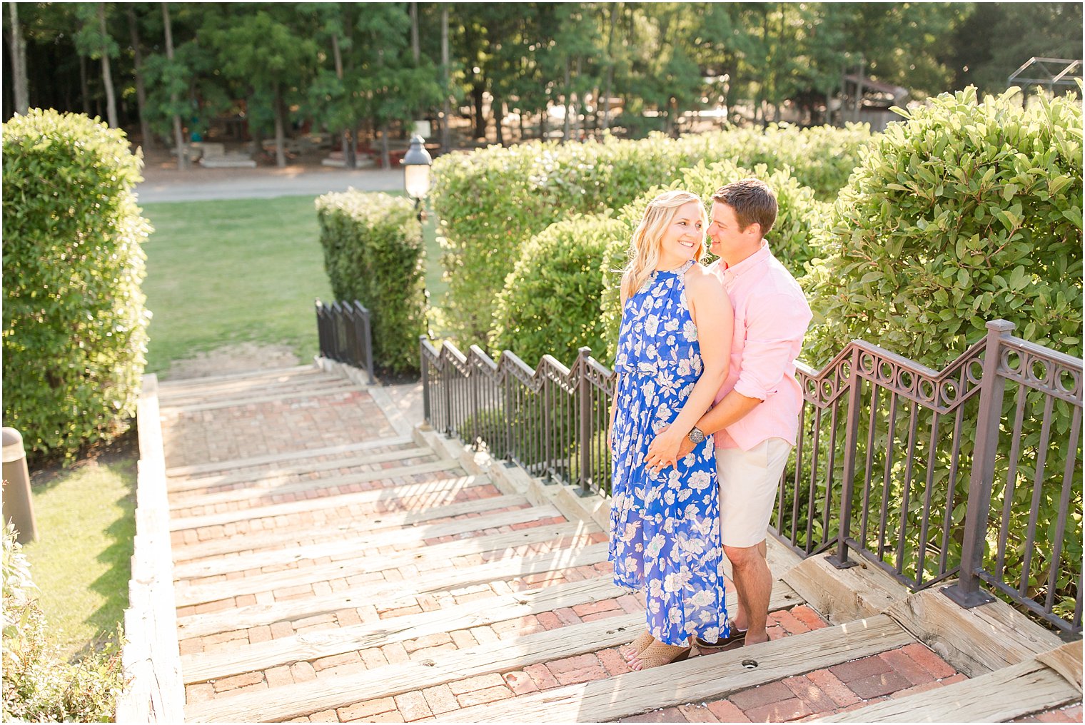 Engaged couple stands on steps at Laurita Winery in New Egypt NJ