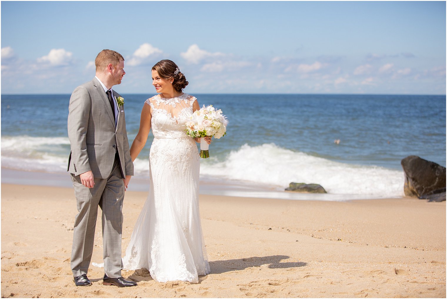 bride and groom on beach photographed by wedding photographer Idalia Photography