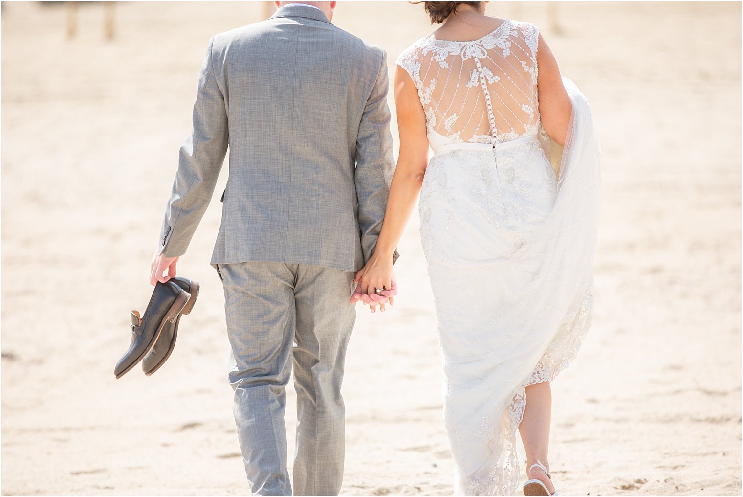 Idalia Photography captures bride and groom holding hands on beach