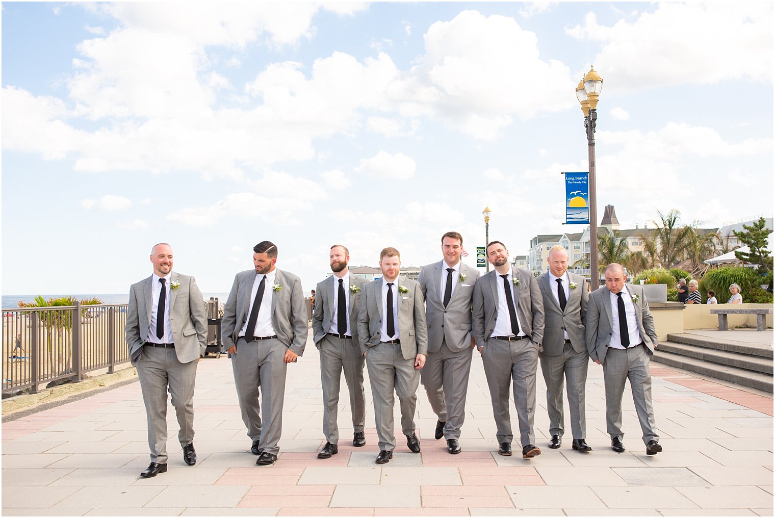 groomsmen walking down boardwalk photographed by Long Branch NJ photographer Idalia Photography