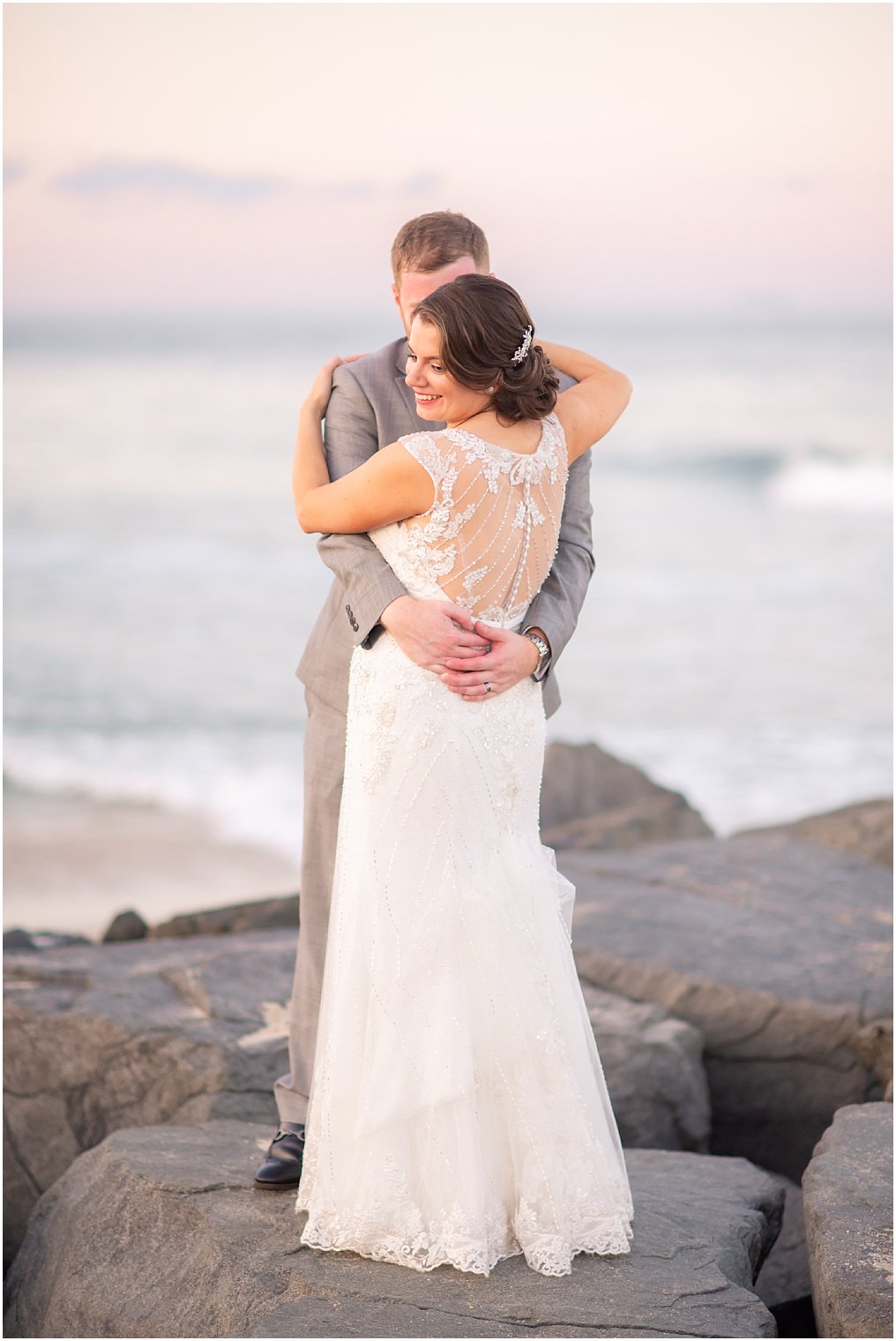 groom hugs his new wife on the beach in Long Branch NJ