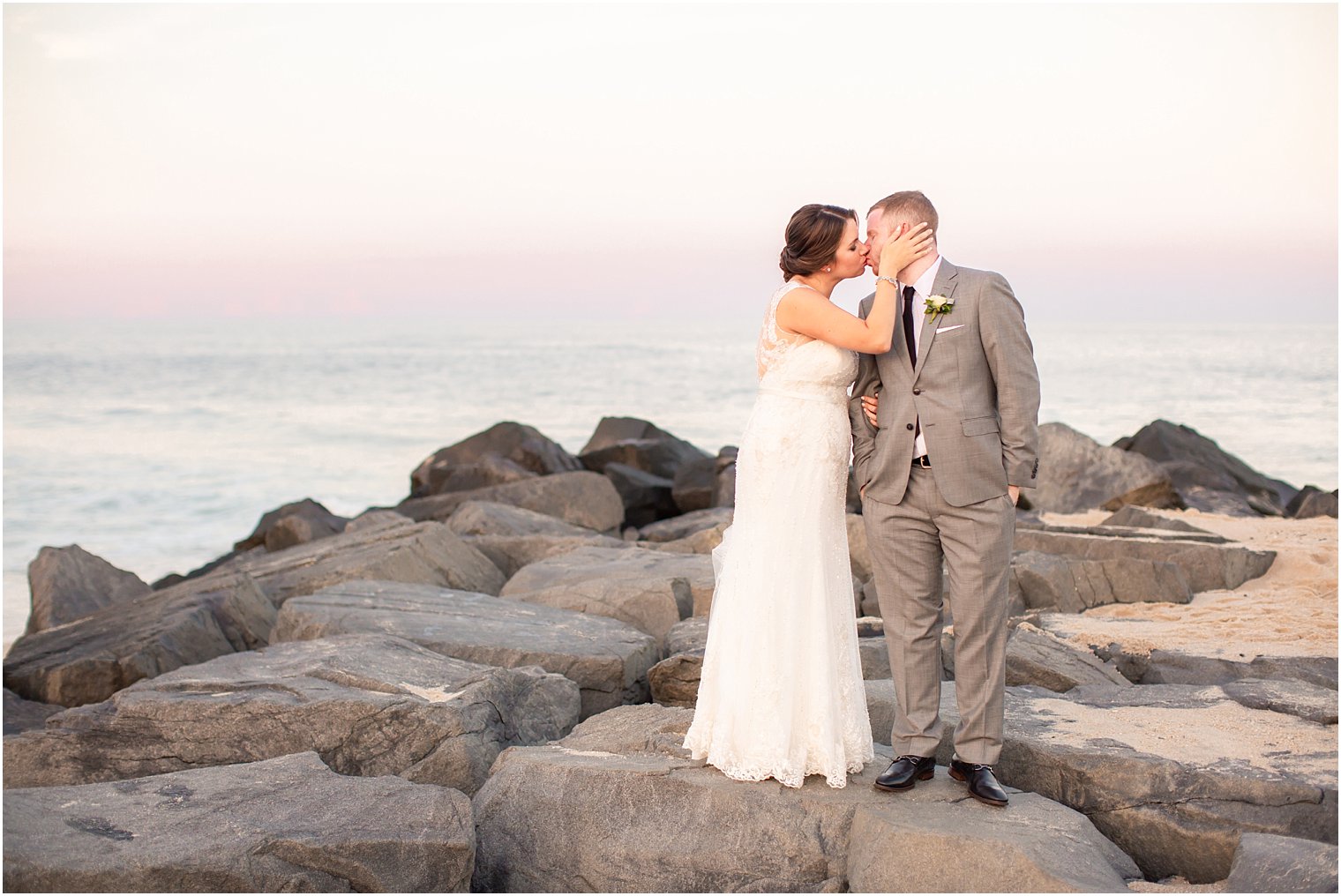 bride and groom kiss at Long Branch NJ beach photographed by Idalia Photography