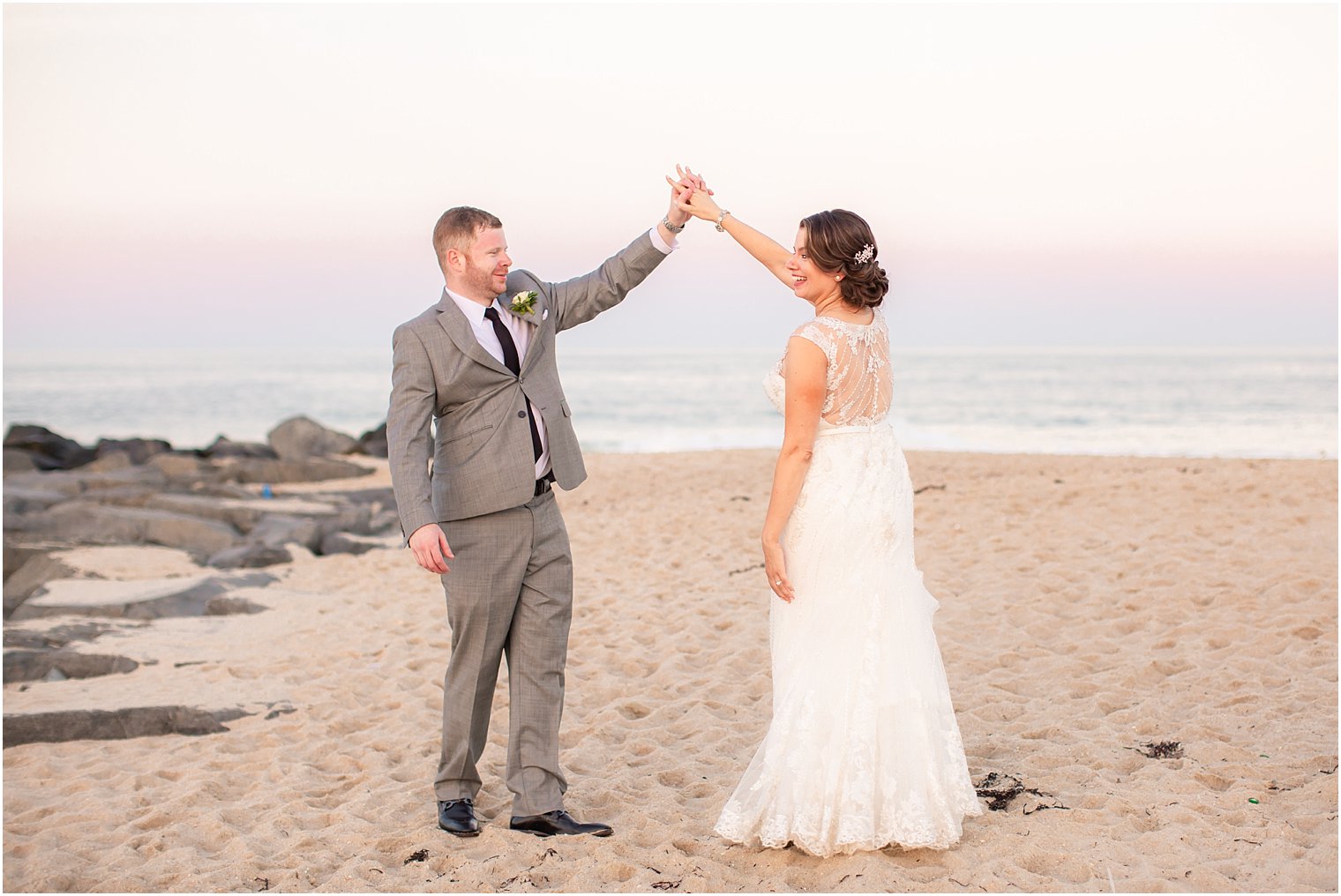 married couple dances on beach at Ocean Place Resort and Spa photographed by Idalia Photography