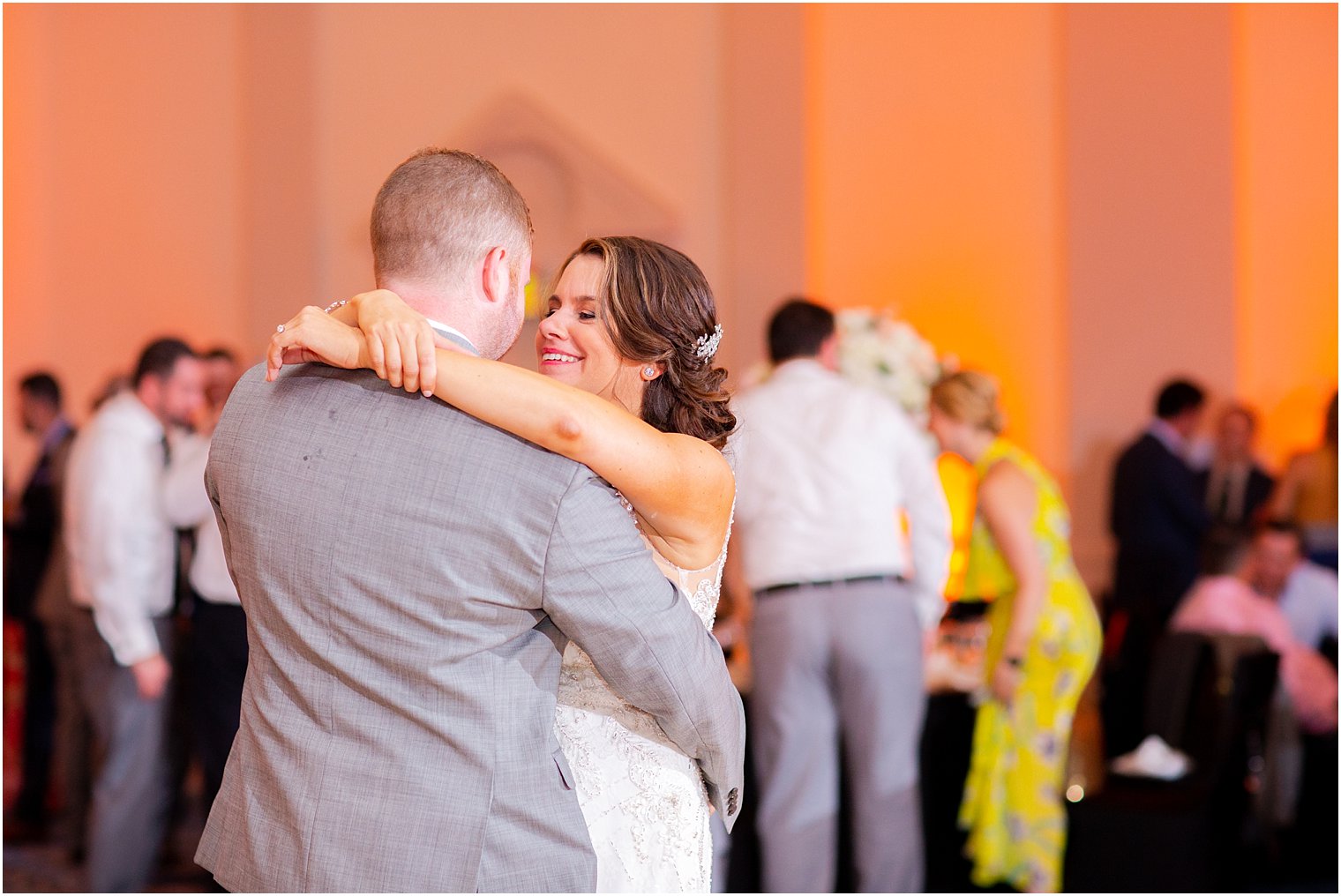 bride smiles at groom during dance at wedding reception at Ocean Place Resort and Spa