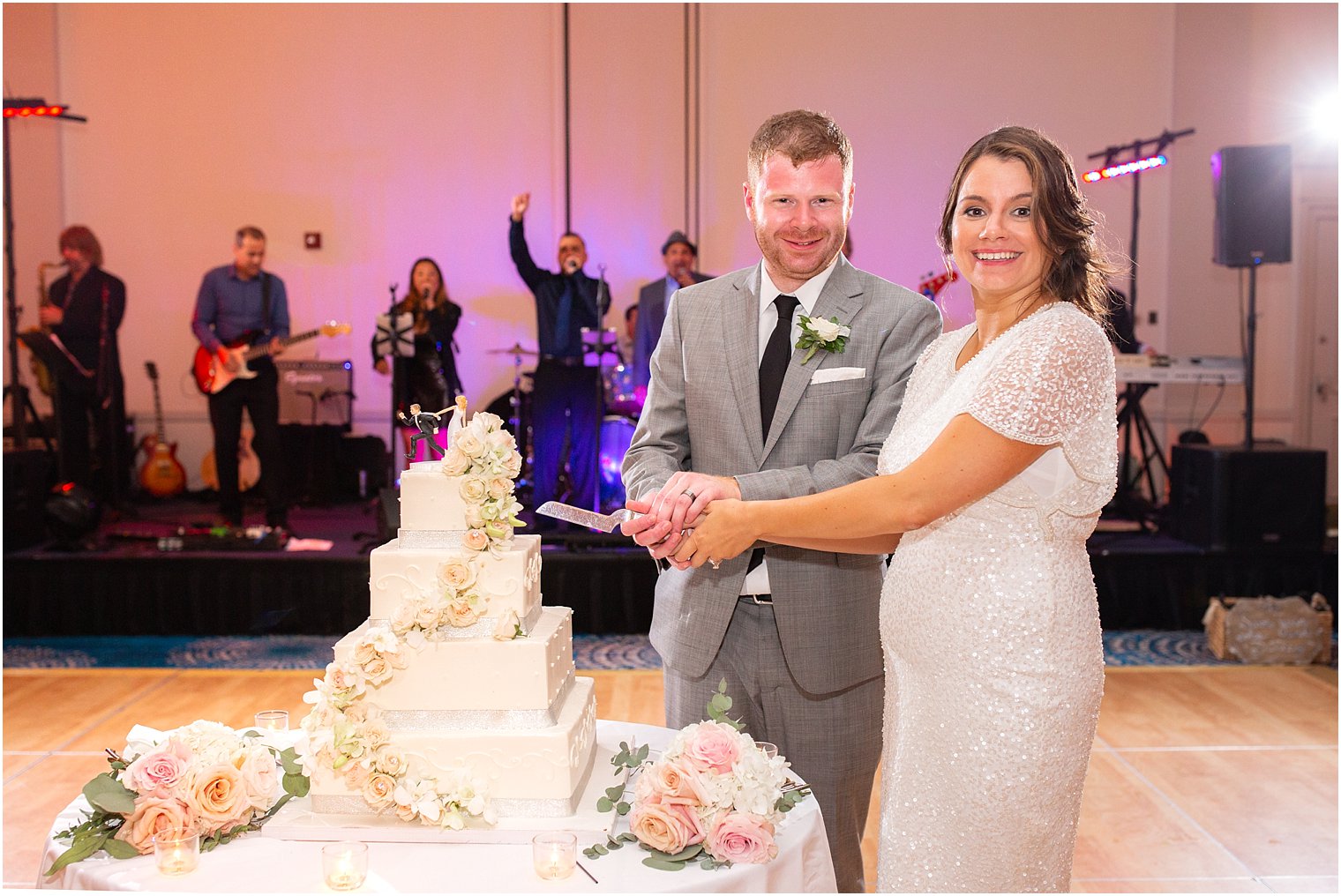 bride and groom cutting cake by Palermo's Bakery photographed by Idalia Photography