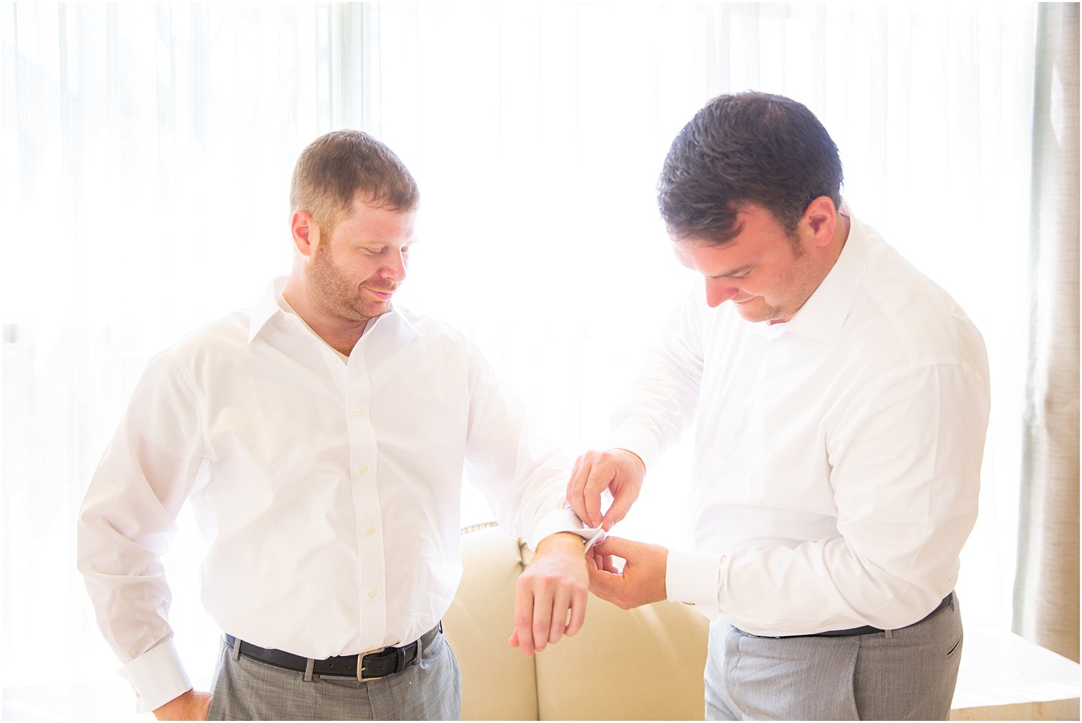 Groom and groomsman getting ready at Ocean Place Resort and Spa