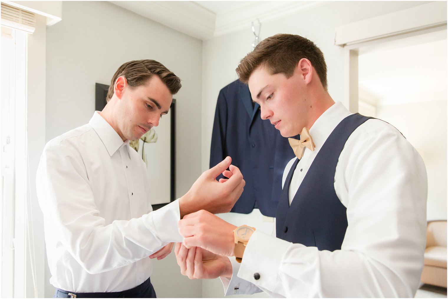 groomsman helps groom get ready on wedding day at Park Savoy Estate 