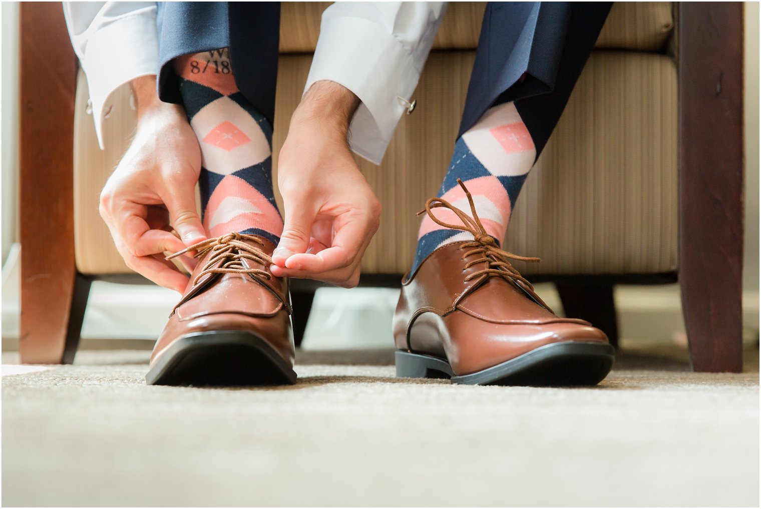groom with custom navy and coral socks photographed by Idalia Photography