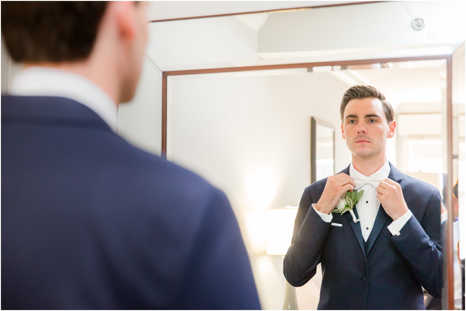groom adjusts tie before Park Savoy Estate wedding day photographed by Idalia Photography