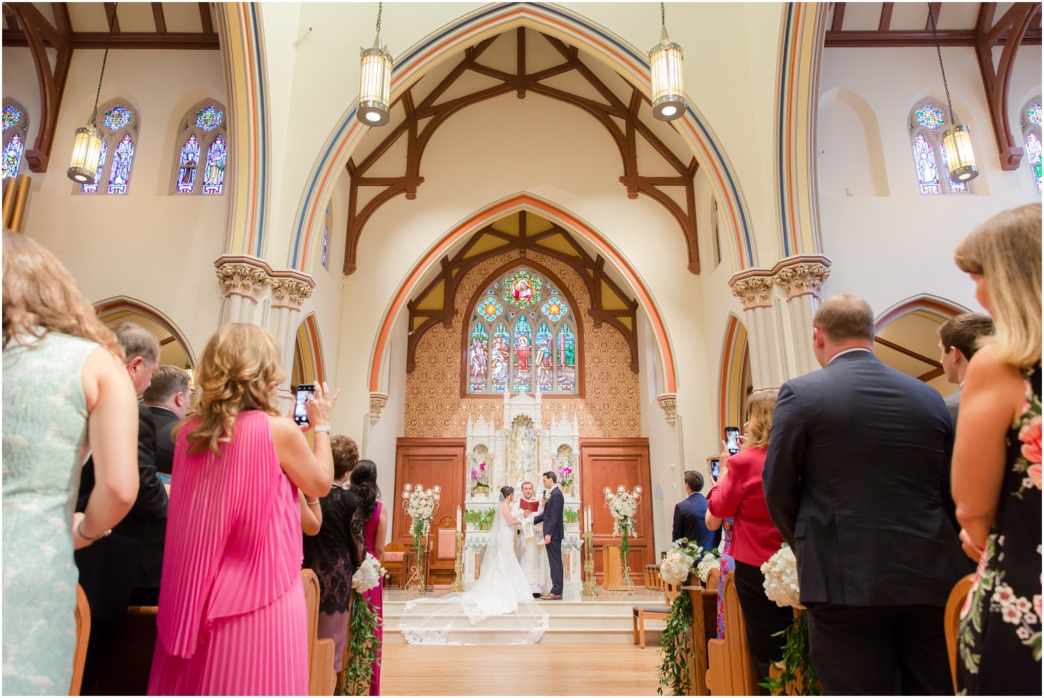 bride and groom exchange wedding vows in NJ church photographed by Idalia Photography