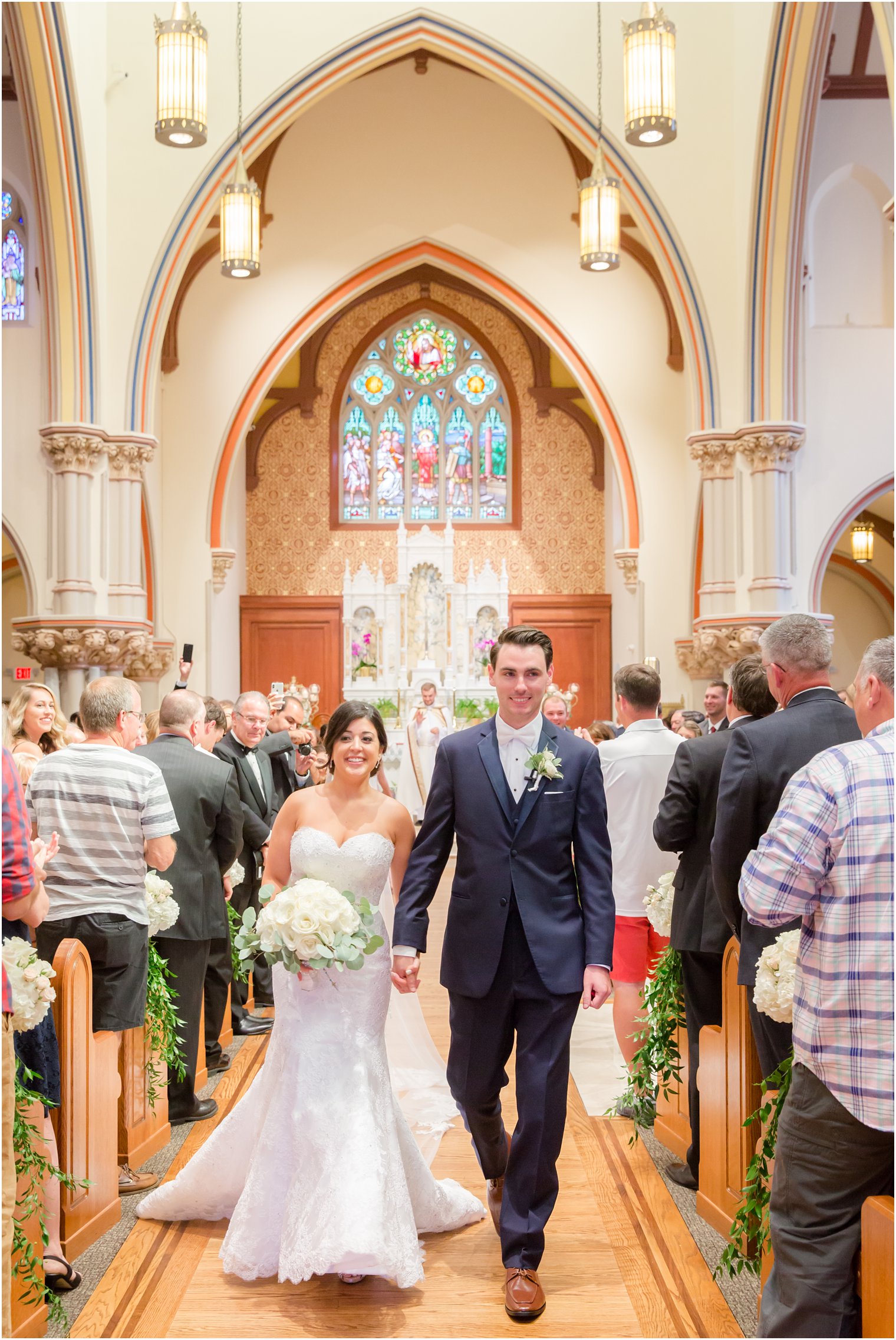 newlyweds in NJ church after ceremony photographed by Idalia Photography