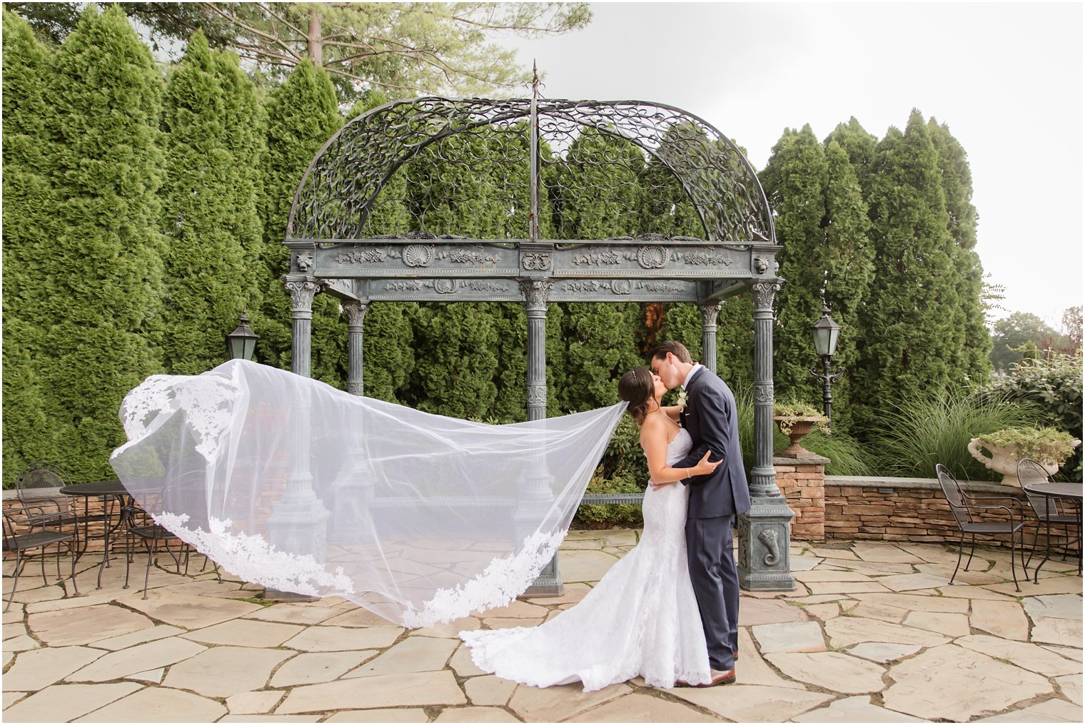 bride and groom kiss in gardens of Park Savoy Estate 