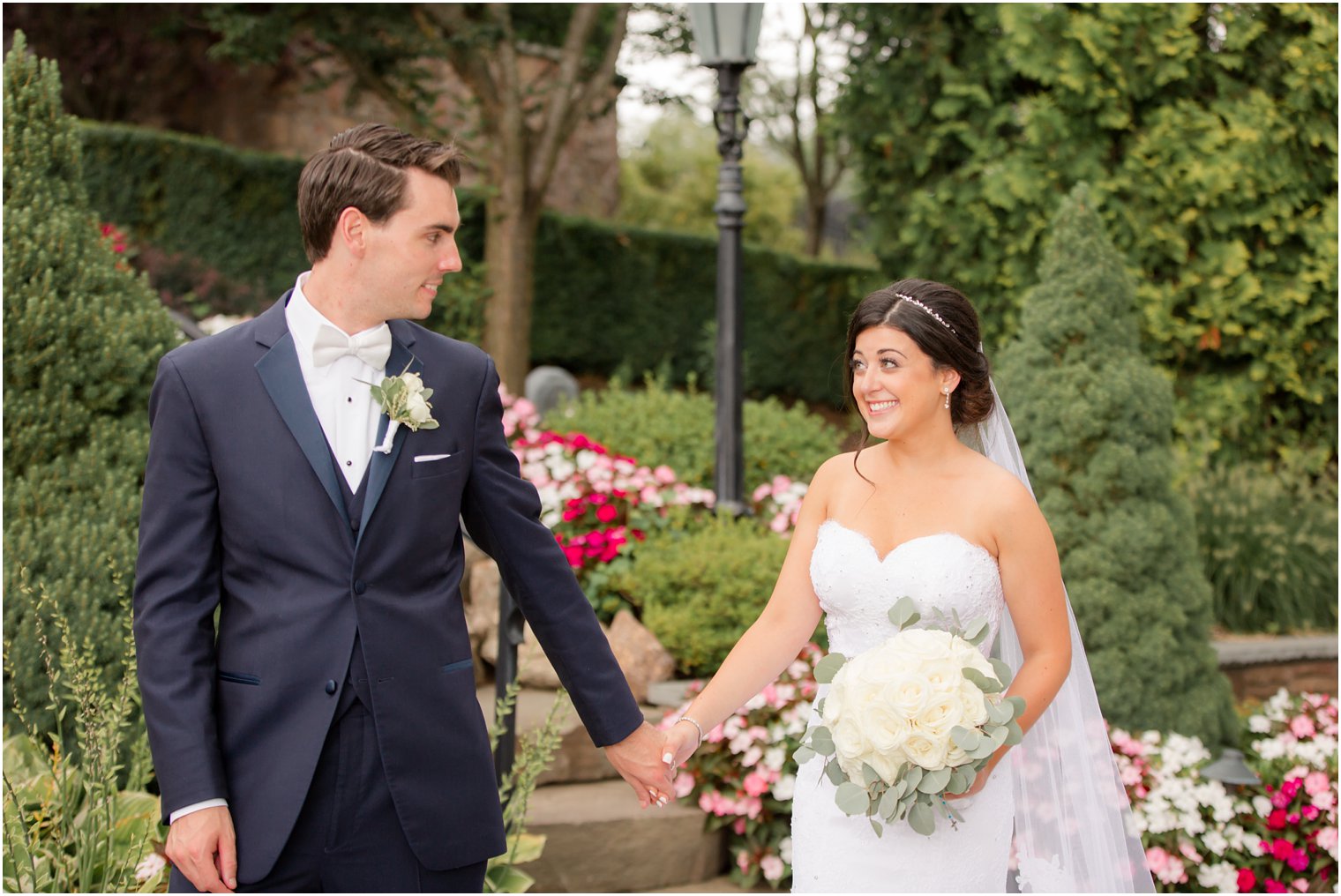 bride and groom hold hands at Park Savoy Estate photographed by Idalia Photography