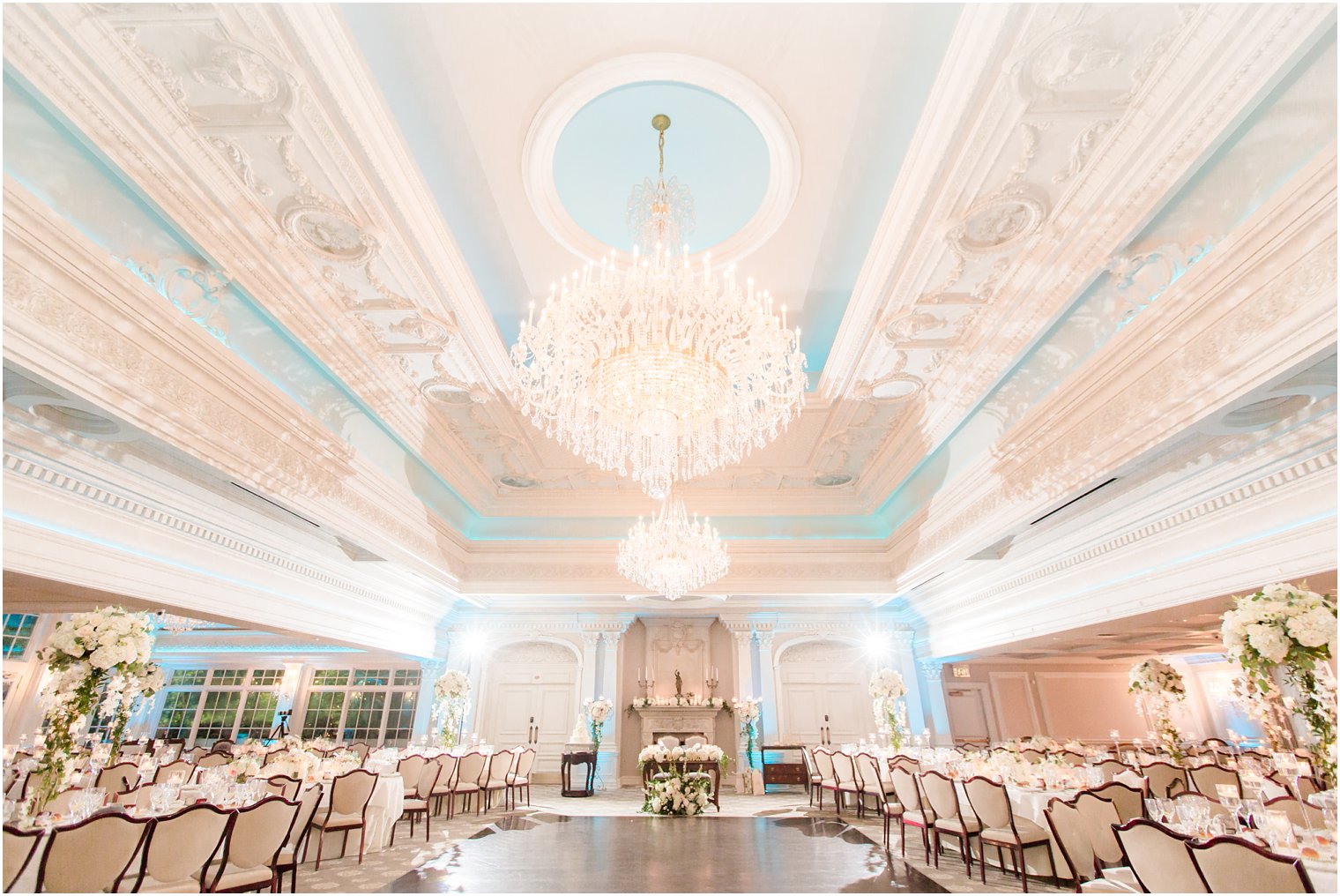 elegant ballroom at Park Savoy Estate with ivory and green floral centerpieces by Crest Florist