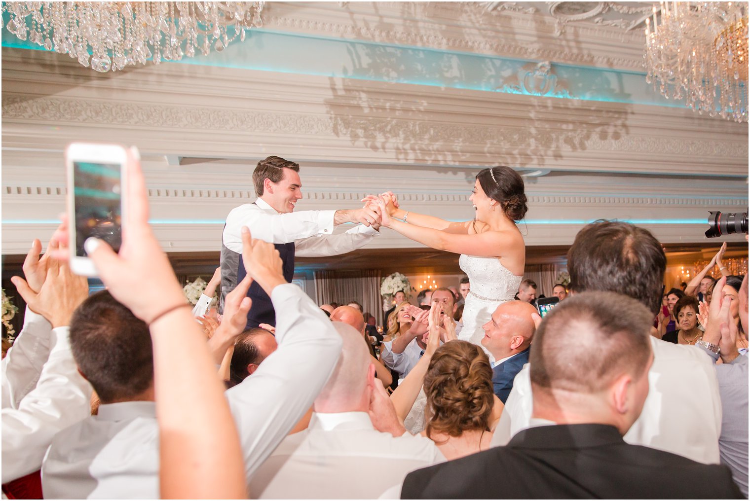 bride and groom lifted up on dance floor at Park Savoy Estate wedding reception