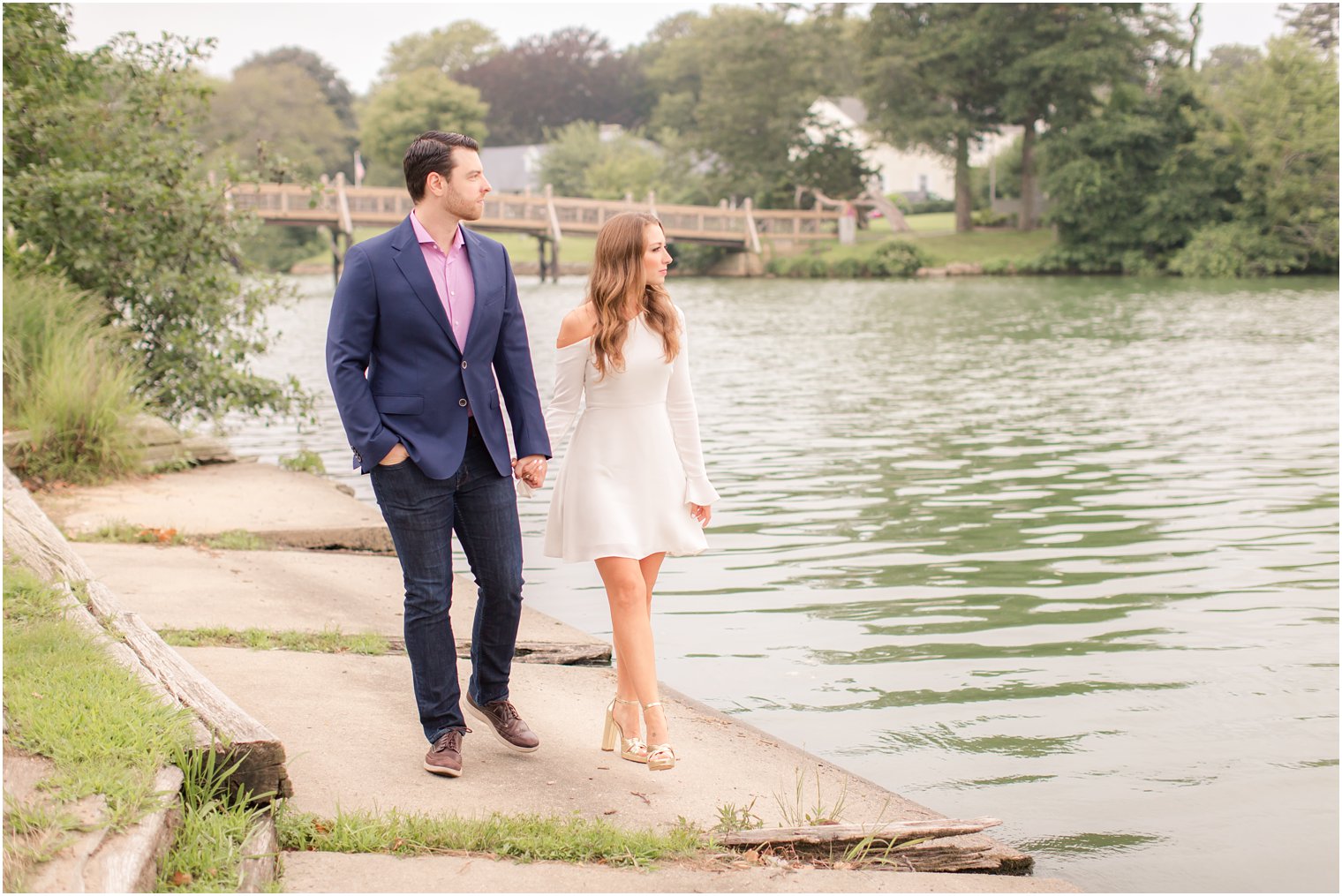 bride and groom walking by lake during Spring Lake NJ Engagement session