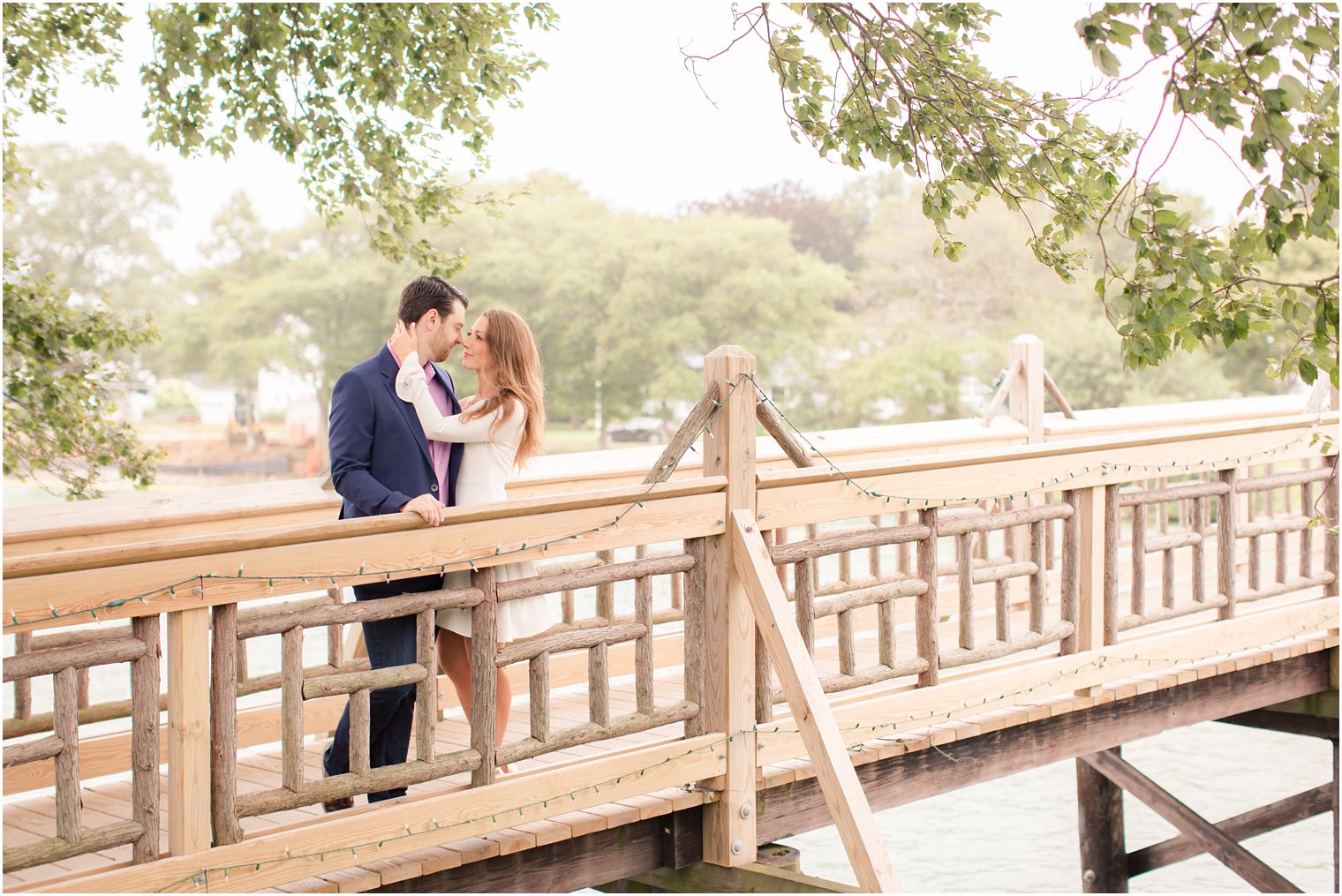 romantic moment on a bridge during Spring Lake NJ engagement session