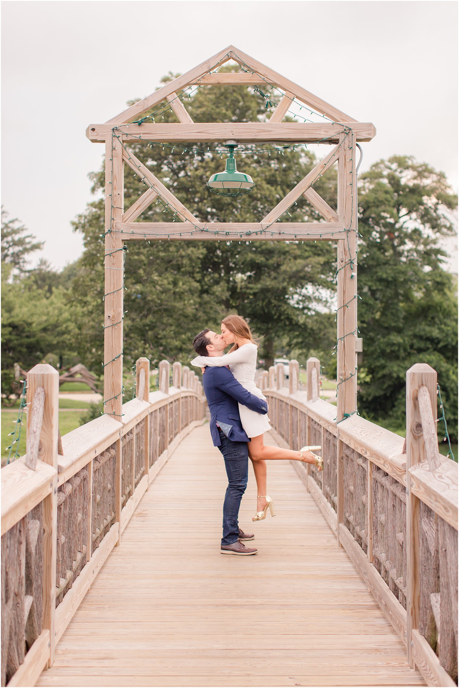 bride picked up by groom while kissing during Spring Lake NJ Engagement session