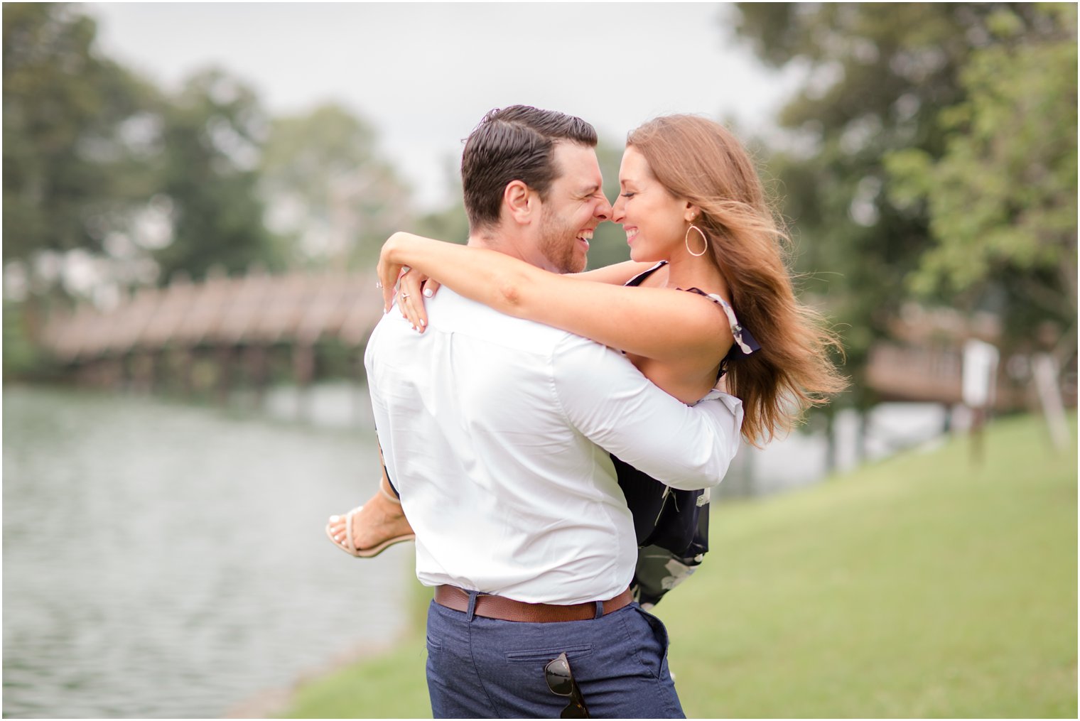 couple laughs during engagement session with Idalia Photography at Spring Lake NJ