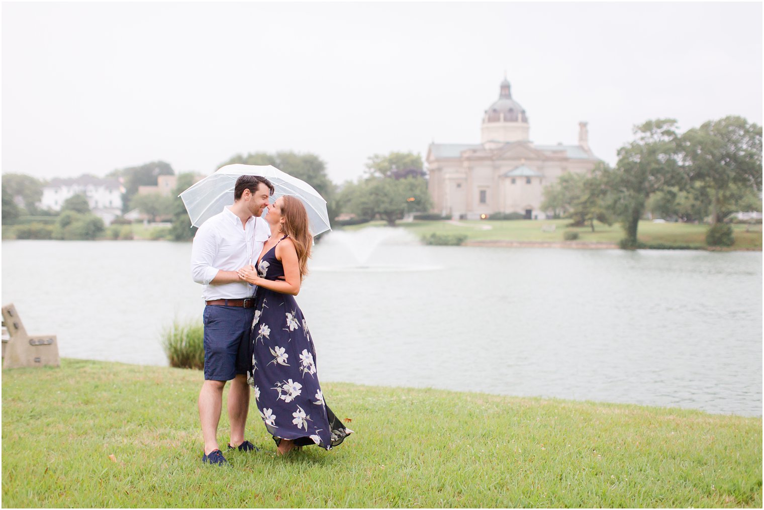 engaged couple poses under umbrella during Spring Lake NJ Engagement session