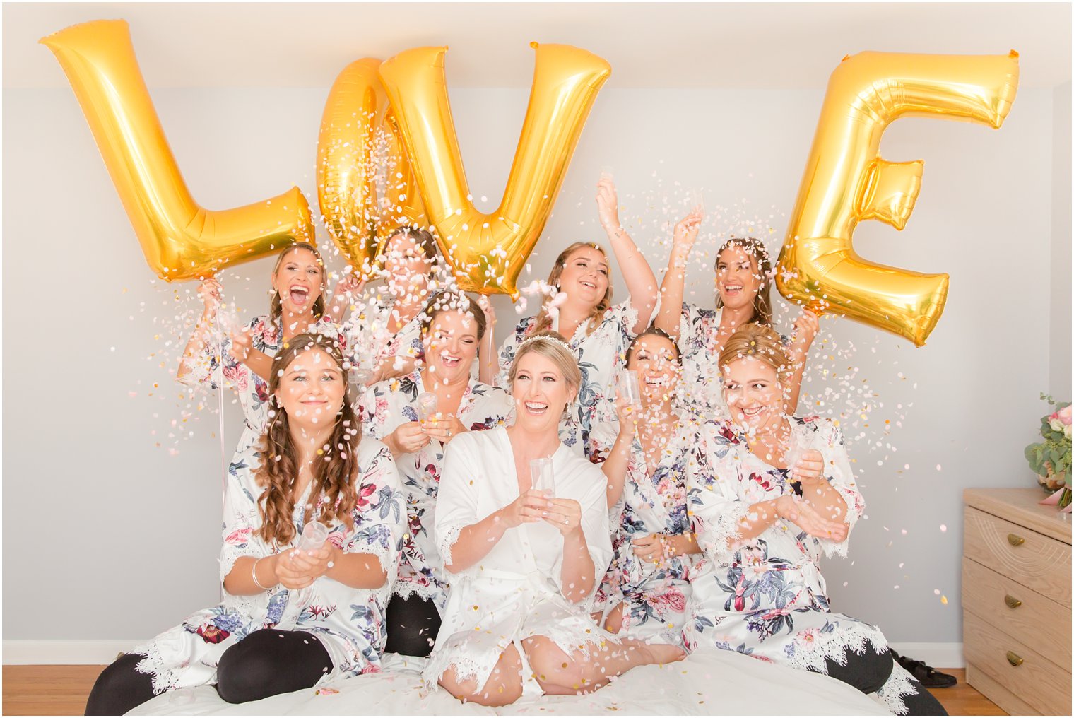 bride and bridesmaids with confetti poppers getting ready for Palace at Somerset Park wedding