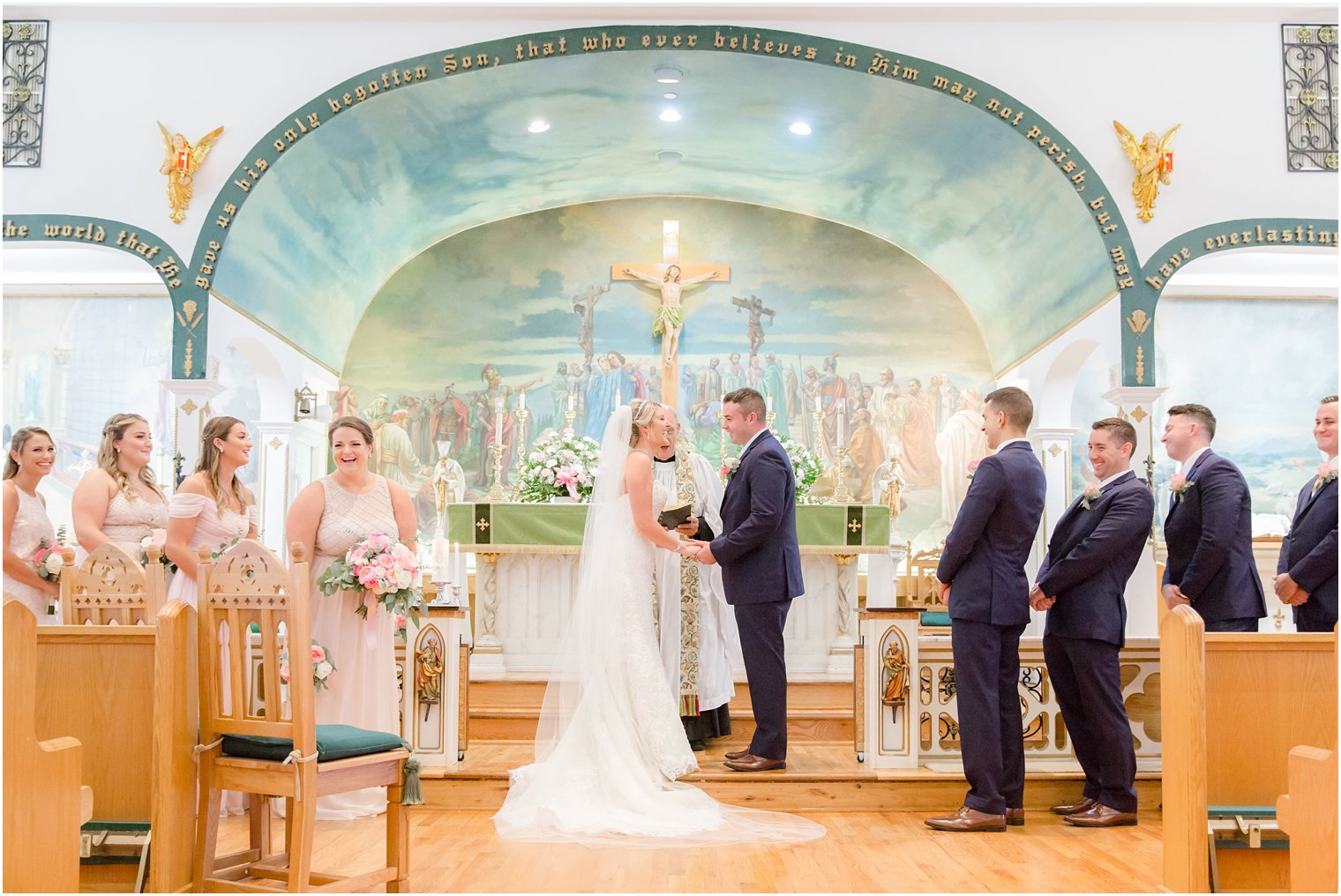 bride and groom exchange vows in church ceremony during New Jersey wedding day 