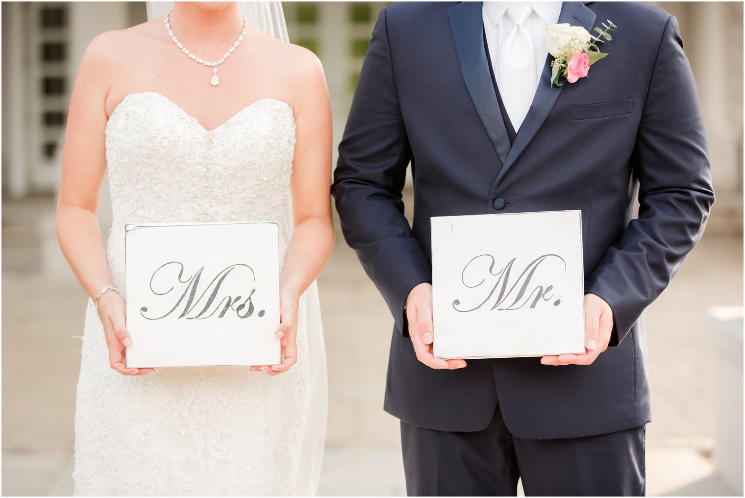 bride and groom hold Mrs. and Mr. signs during wedding portraits at Palace at Somerset Park