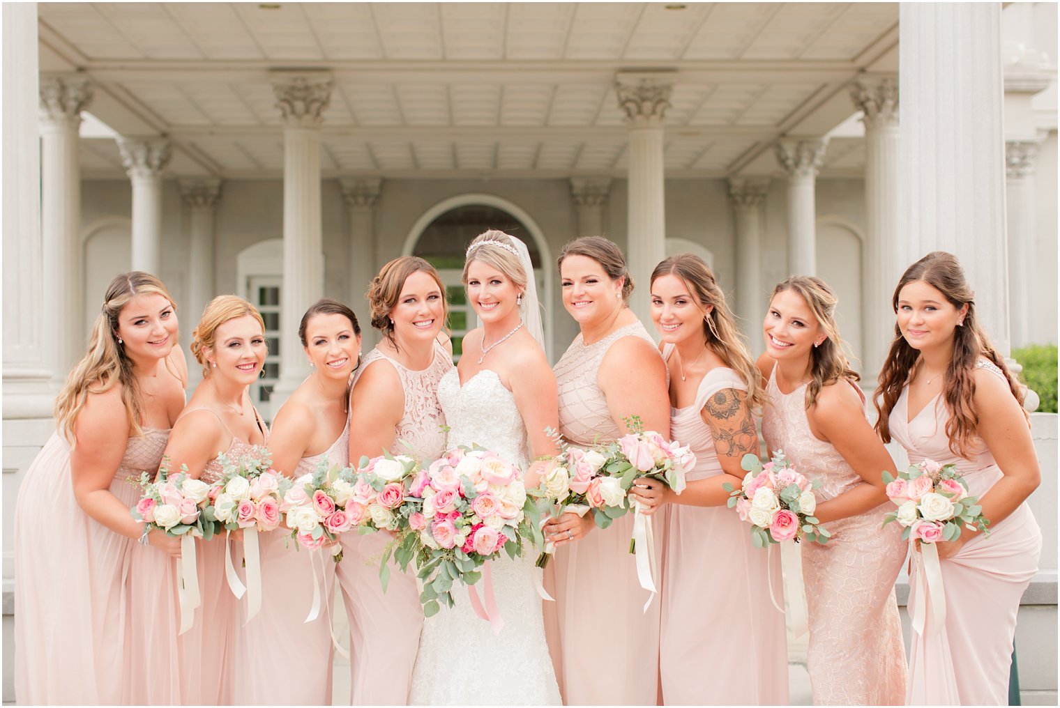 bride poses with bridesmaids with bouquets by Ashley's Floral Beauty at the Palace at Somerset Park