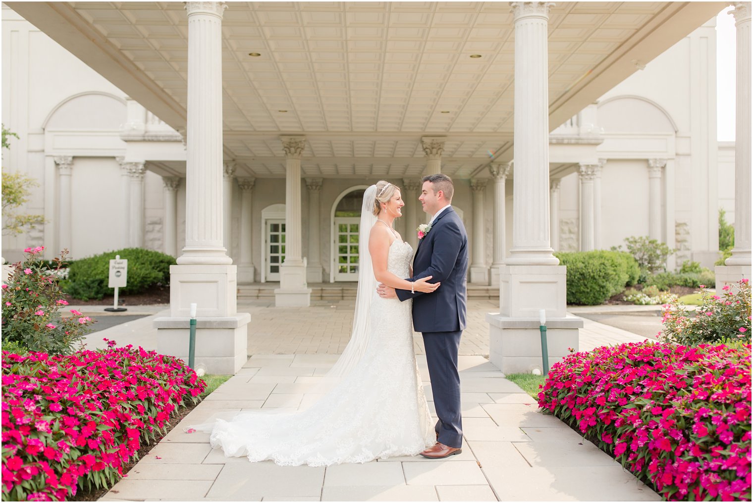 bride and groom pose outside the Palace at Somerset Park photographed by Idalia Photography