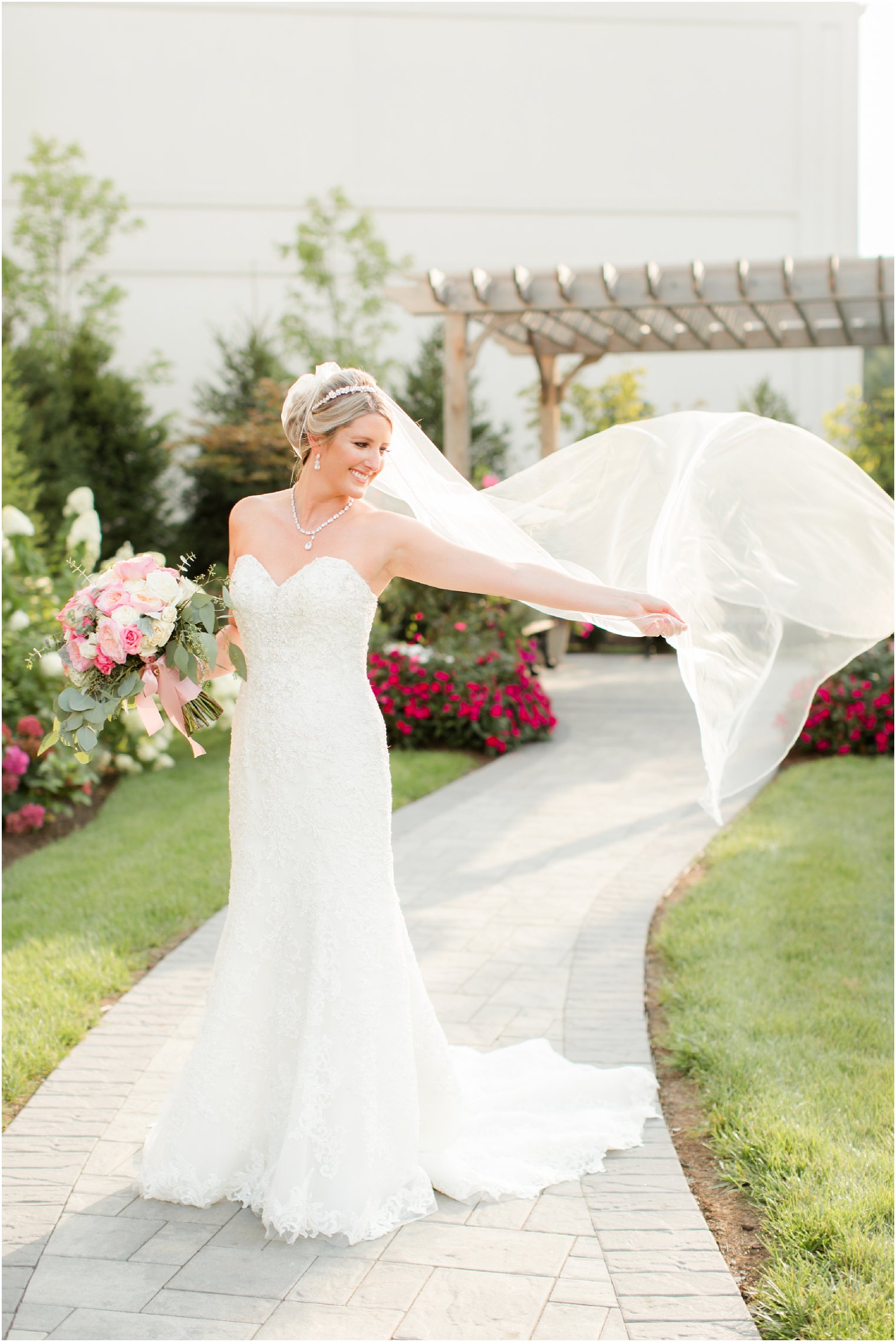 bride tosses veil in wedding portrait at the Palace at Somerset Park by Idalia Photography