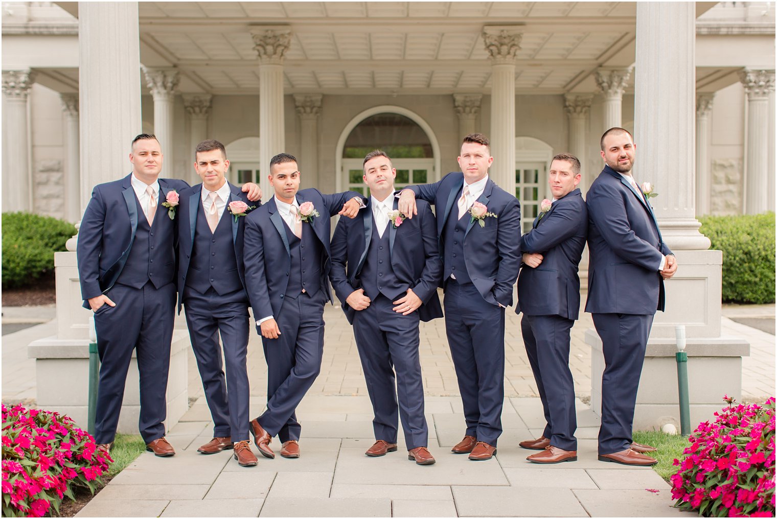 grooms pose in navy suits for NJ wedding photographer Idalia Photography at the Palace at Somerset Park