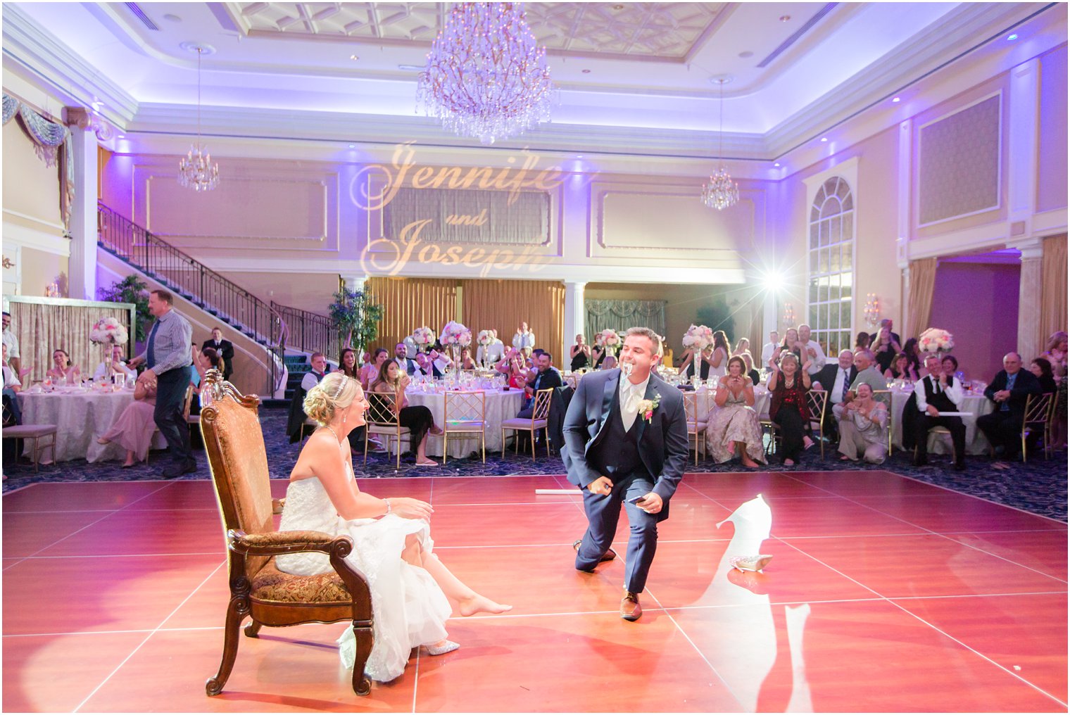 groom takes garter during wedding reception at the Palace at Somerset Park