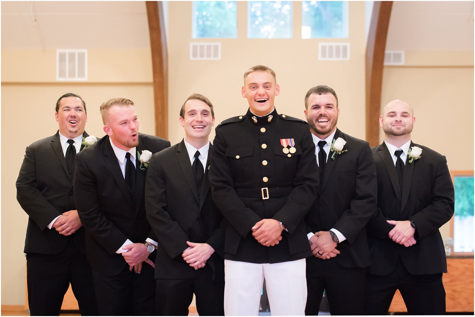 Groom and groomsmen laugh during wedding portraits at Jasna Polana