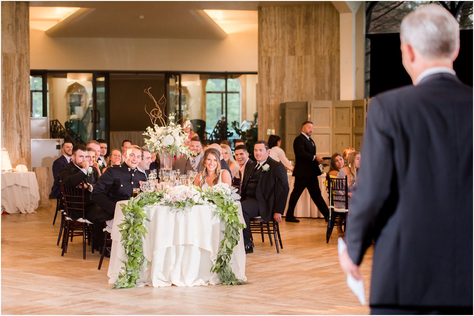 couple listens to wedding toast by father of the bride at Jasna Polana