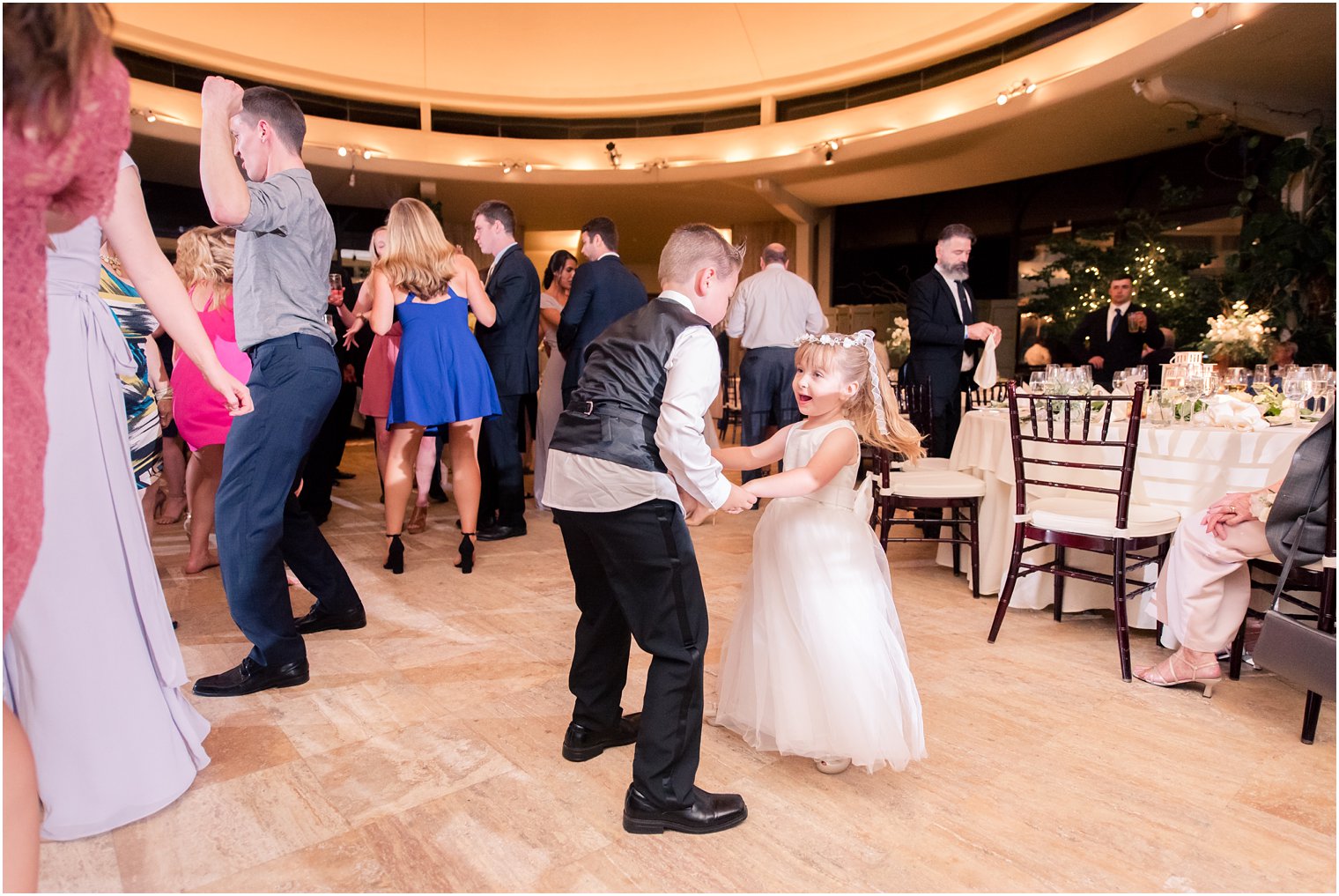flower girl dances at wedding reception with big brother photographed by Idalia Photography