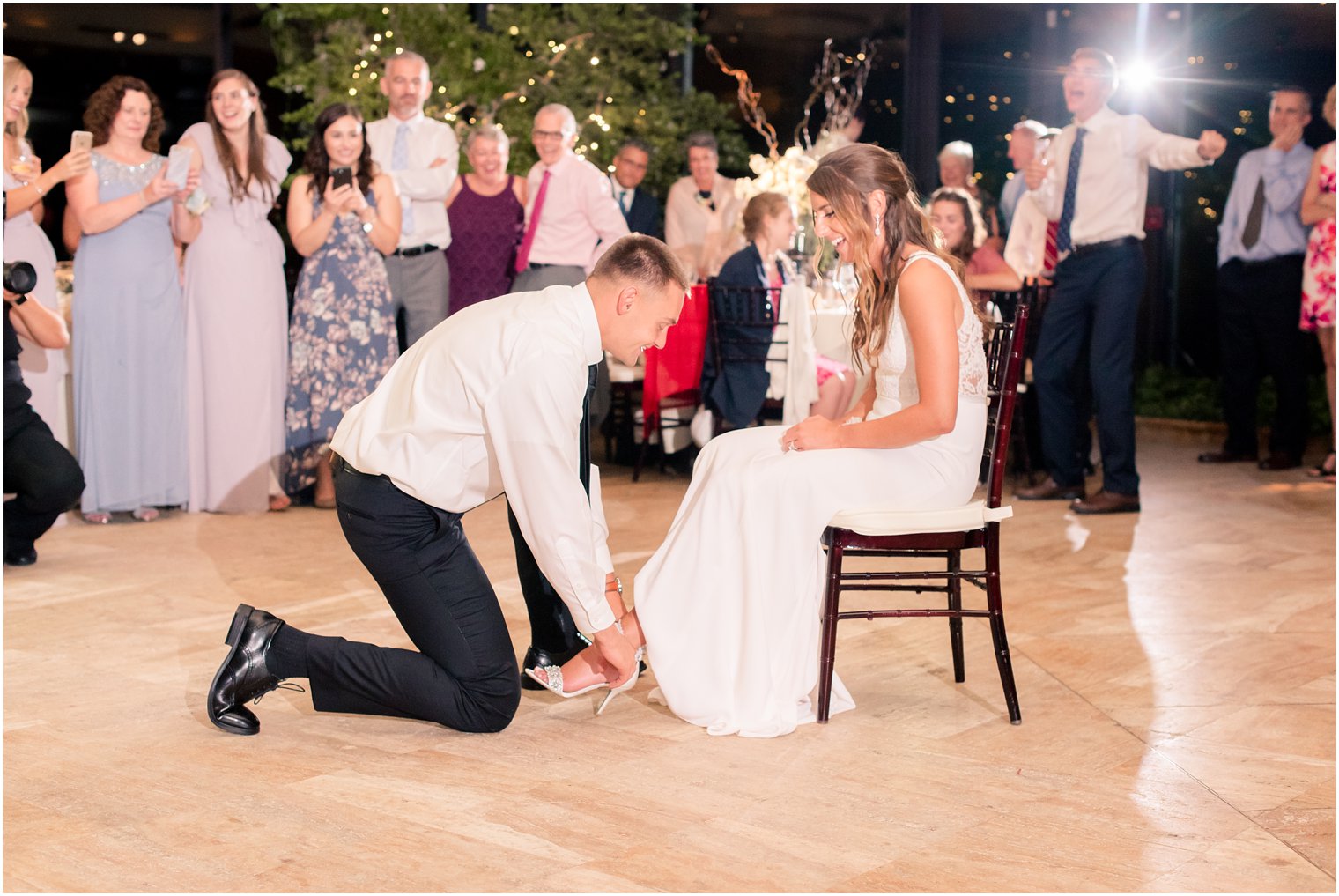 groom removes garter at Jasna Polana wedding reception in NJ