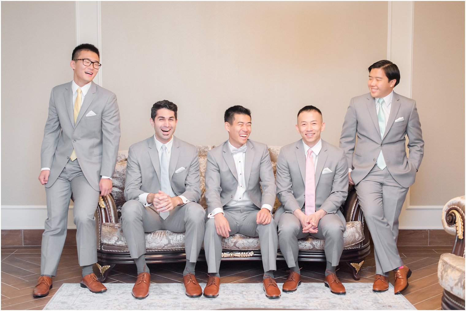 Groom and groomsmen in grey suits with pastel ties from Men's Wearhouse photographed by NJ wedding photographer Idalia Photography