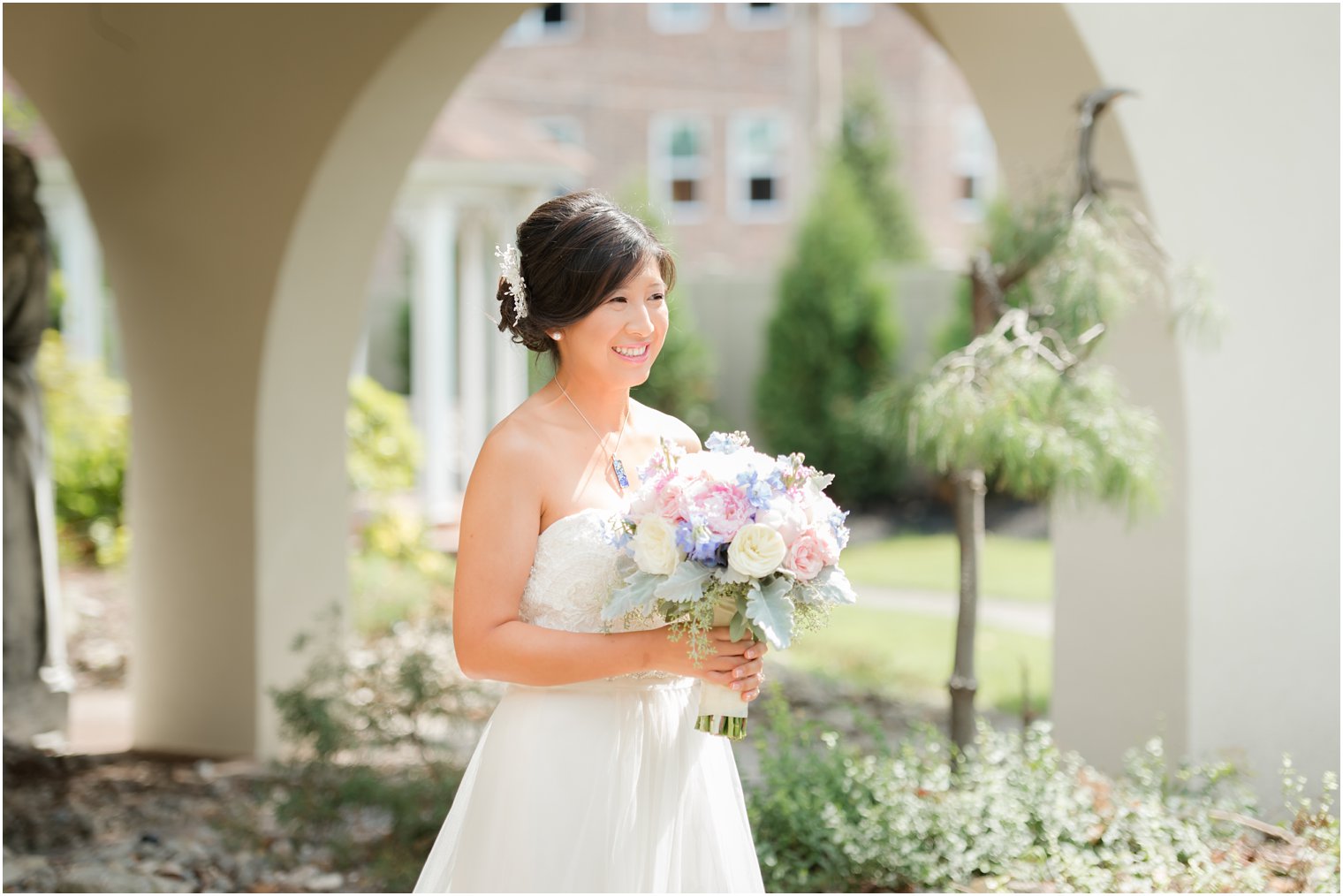 bride in wedding gown from David's Bridal with pastel pink and purple wedding bouquet from Secret Garden