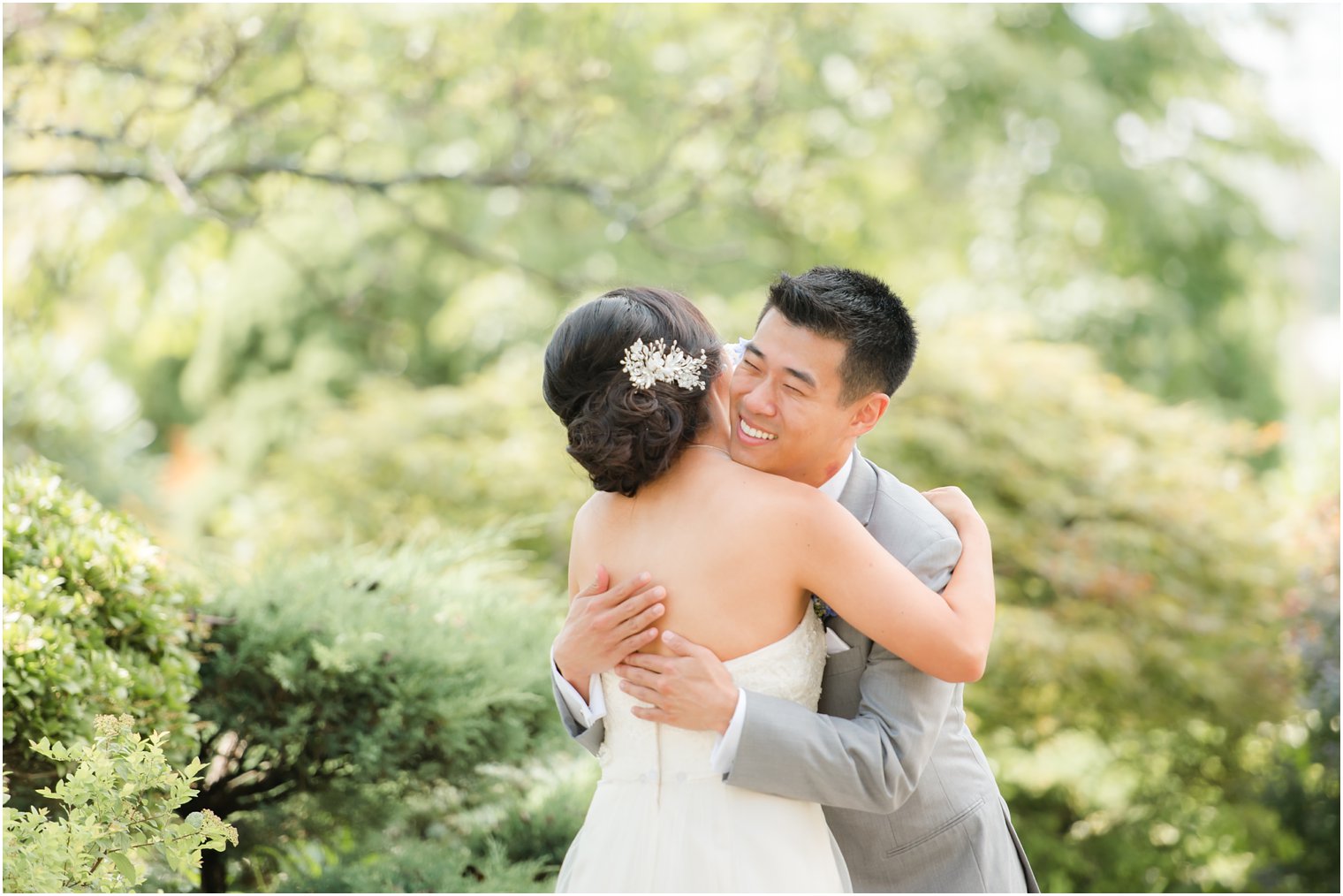 bride and groom embrace during first look on wedding day in New Jersey at The Bethwood